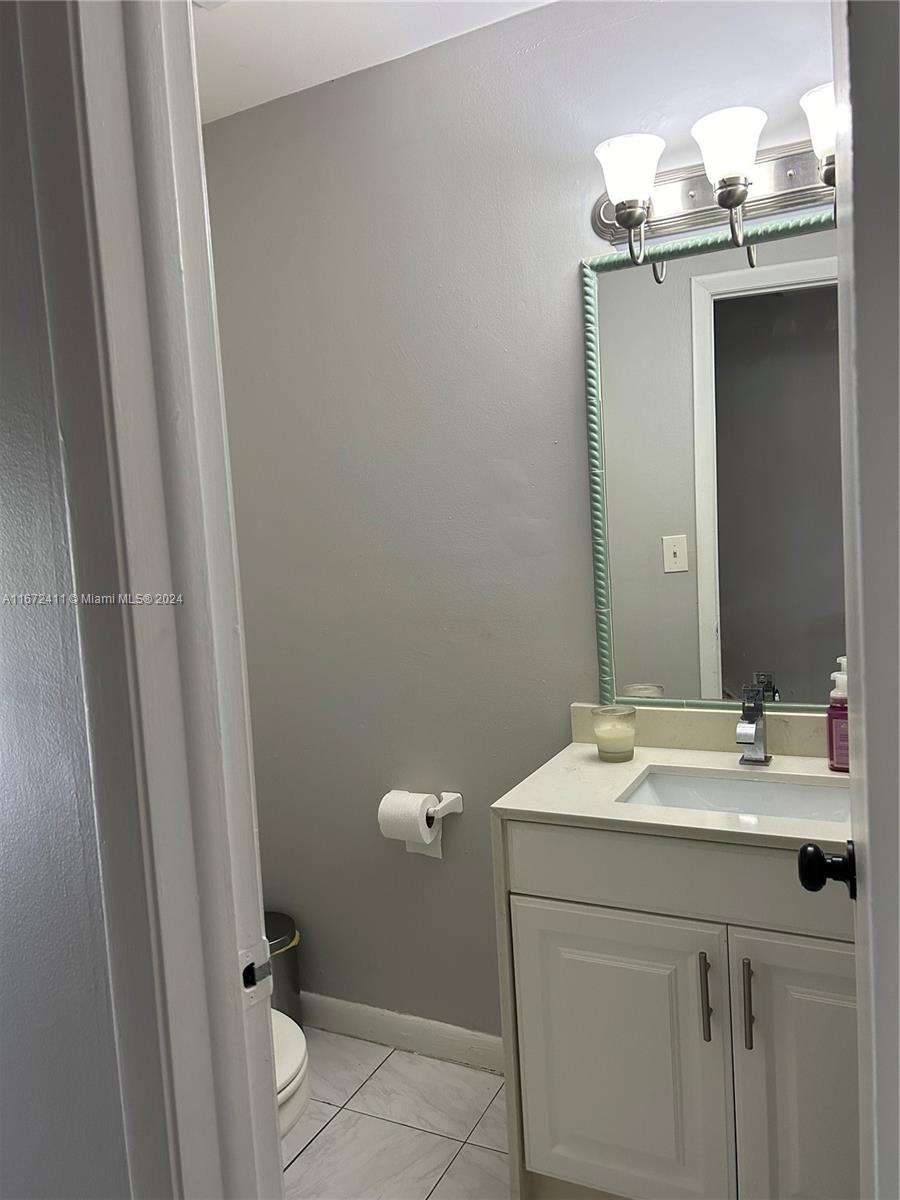 West End Miami, FL 33193 - Photo 8 of 19 a bathroom with a sink a toilet and a mirror