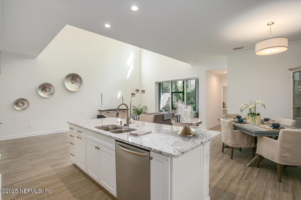 109 Rimini Court Jacksonville, FL 32225 - Photo 11 of 27 a kitchen with a sink dishwasher and a stove with wooden floor