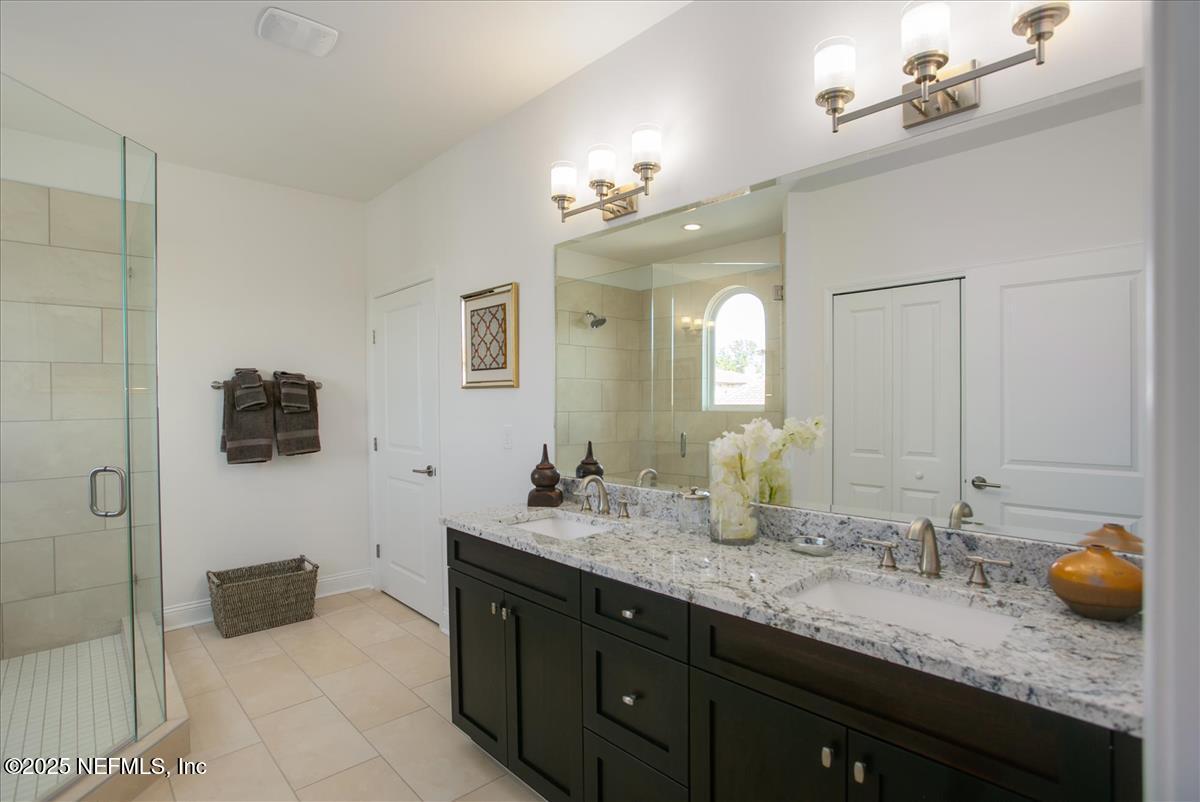 109 Rimini Court Jacksonville, FL 32225 - Photo 17 of 27 a bathroom with a granite countertop sink a large mirror and shower