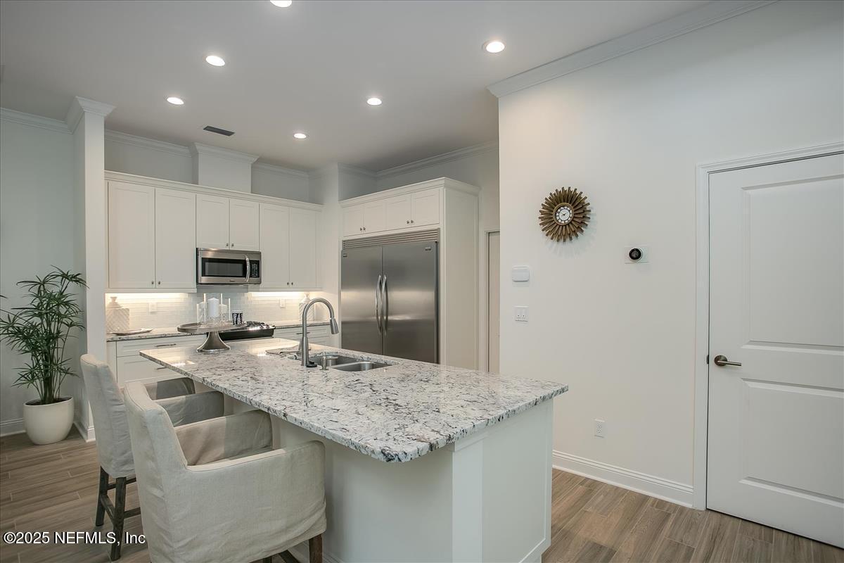 109 Rimini Court Jacksonville, FL 32225 - Photo 8 of 27 a kitchen with kitchen island granite countertop a sink appliances and cabinets