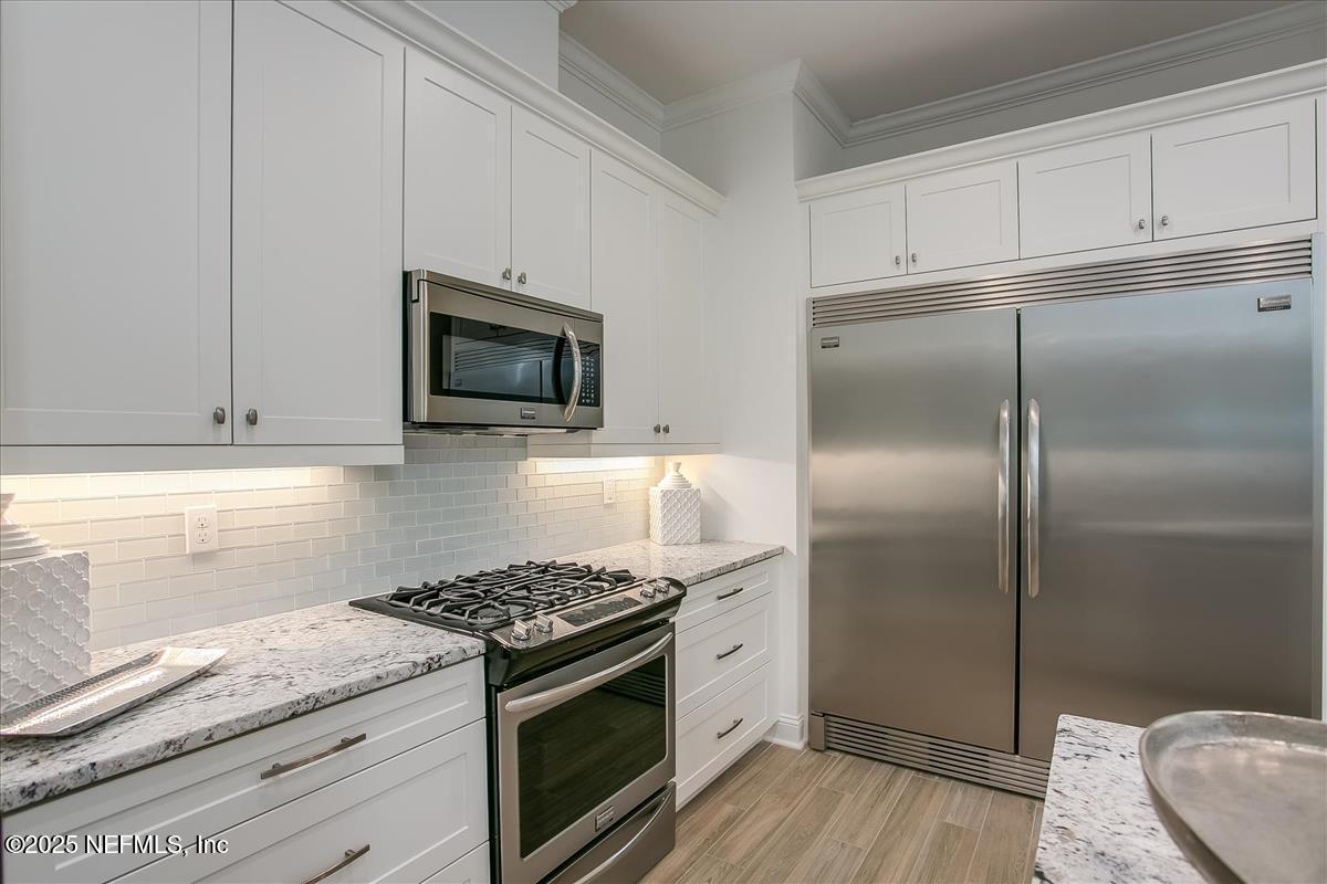109 Rimini Court Jacksonville, FL 32225 - Photo 10 of 27 a kitchen with granite countertop a sink stove and refrigerator