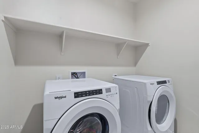 an empty room with fan and windows