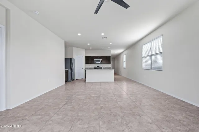 a view of a kitchen with a sink and a refrigerator
