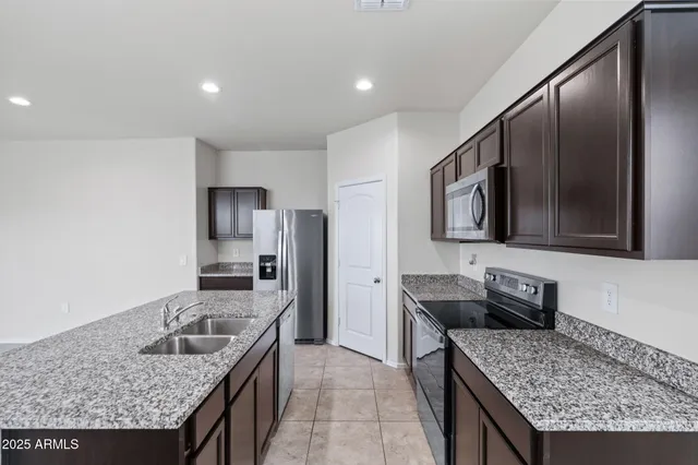 a kitchen with stainless steel appliances a refrigerator and a stove
