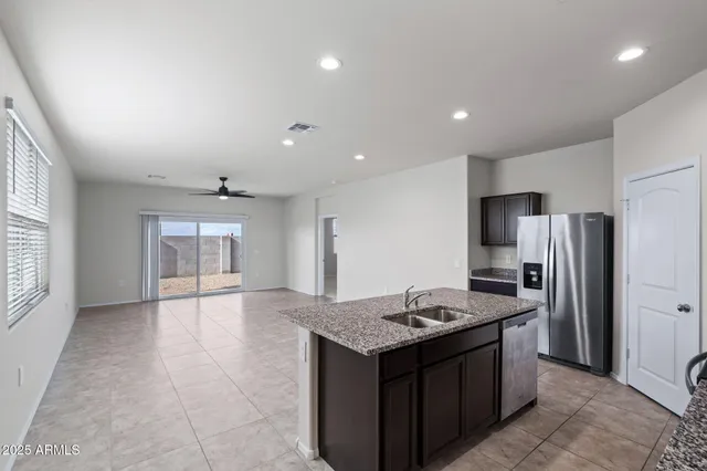 a kitchen with stainless steel appliances granite countertop a sink and a granite counter tops