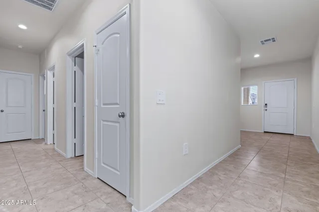 an empty room with windows and closet