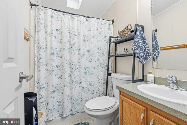 a bathroom with a granite countertop toilet and a sink