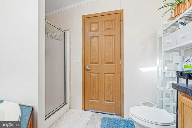 a bathroom with a toilet a sink and shower