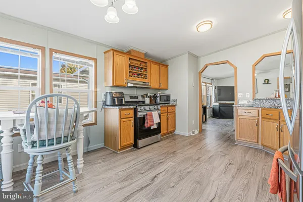 a open kitchen with cabinets a sink and a stove
