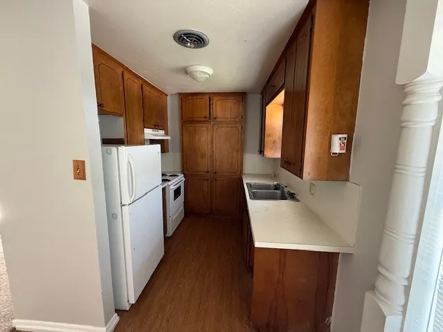 a kitchen with refrigerator cabinets and a sink