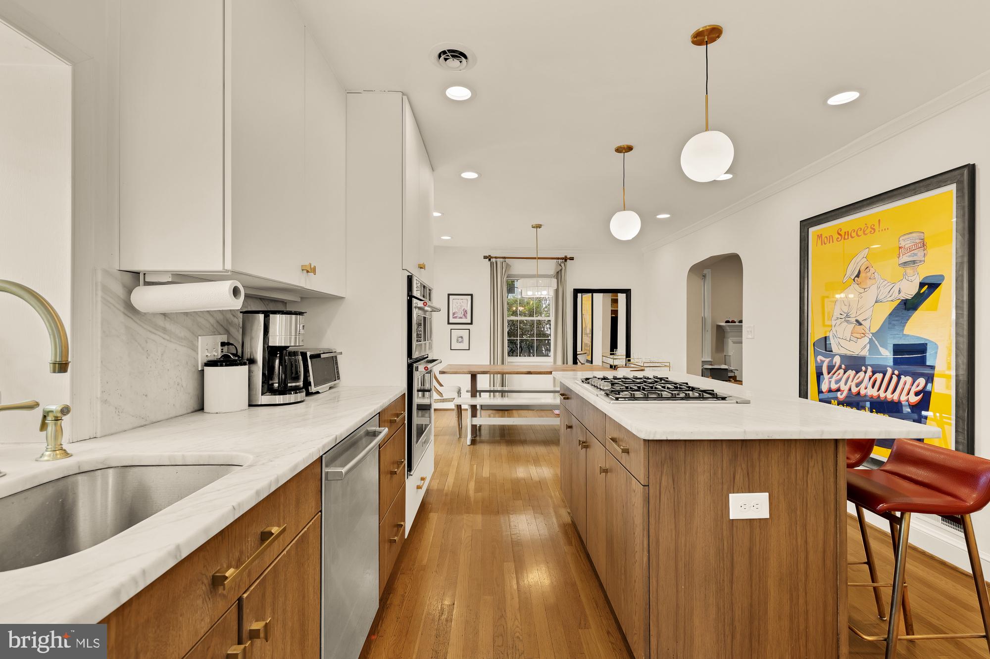7208 Delfield Street Chevy Chase, MD 20815 - Photo 13 of 50 a large kitchen with kitchen island a large island in the center