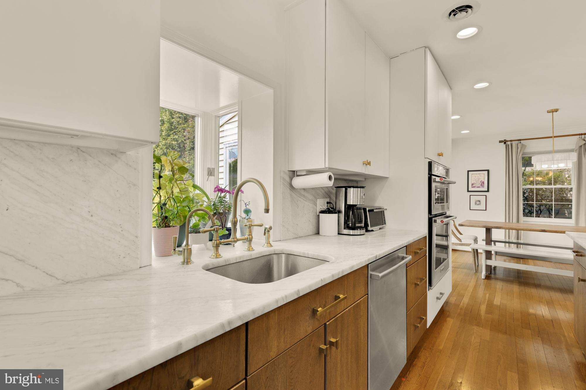 7208 Delfield Street Chevy Chase, MD 20815 - Photo 14 of 50 a kitchen with a sink and a refrigerator