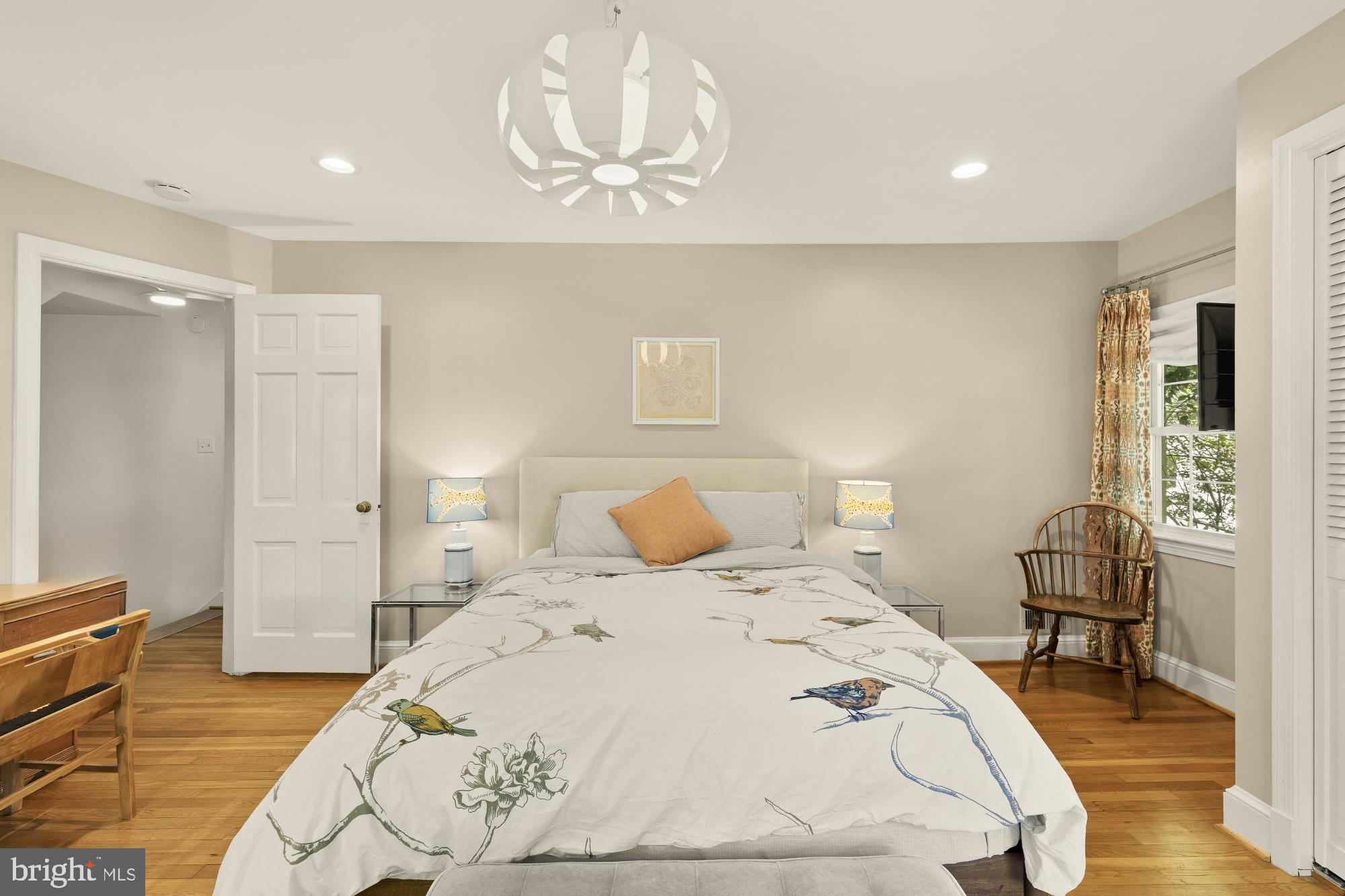 7208 Delfield Street Chevy Chase, MD 20815 - Photo 23 of 50 a bedroom with a bed and wooden floor