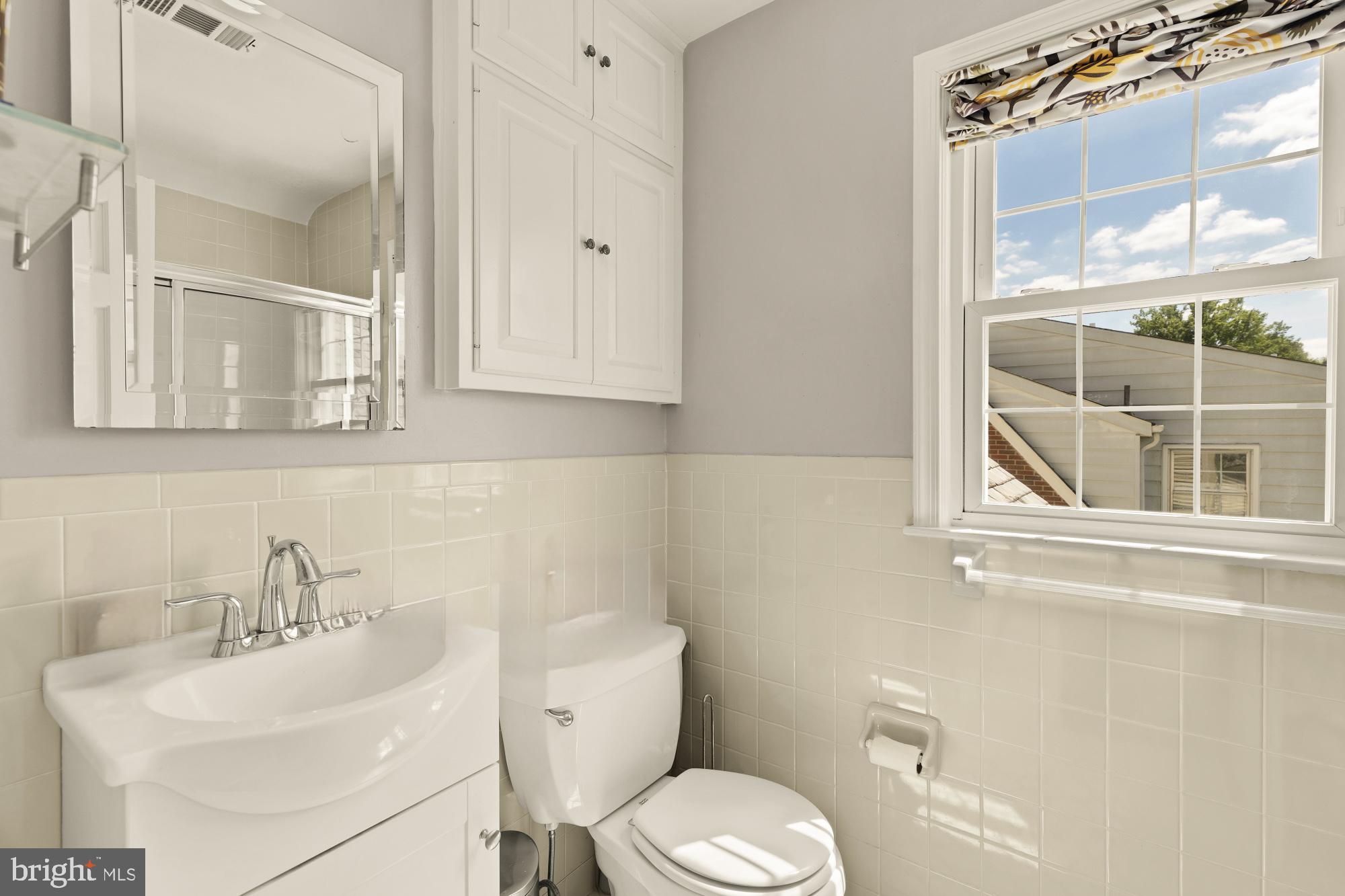 7208 Delfield Street Chevy Chase, MD 20815 - Photo 30 of 50 a bathroom with a toilet a sink and a mirror