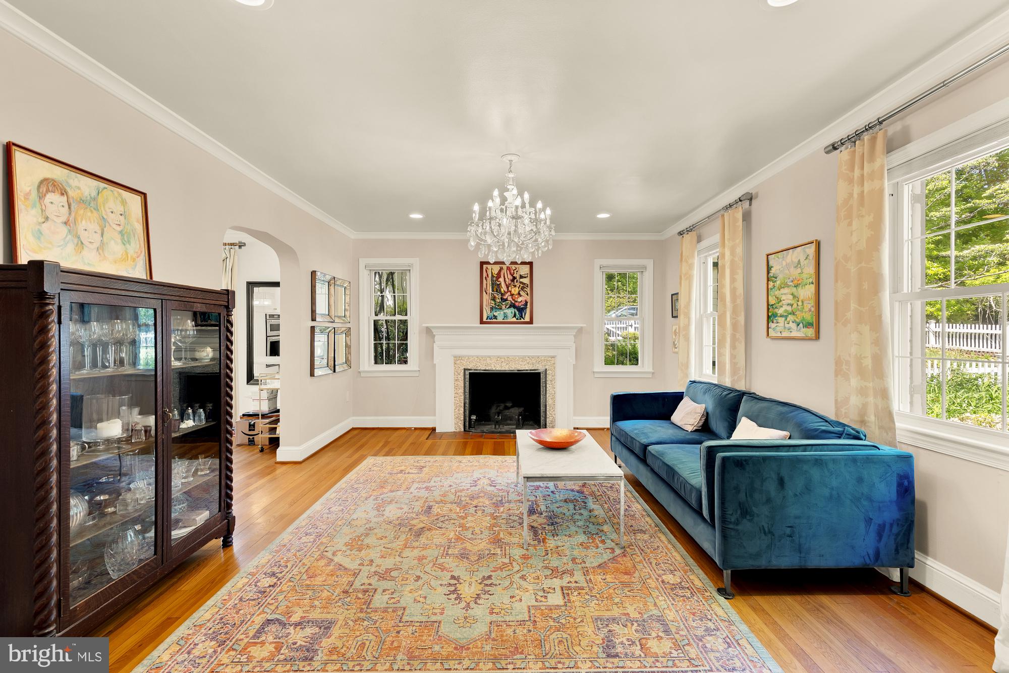 7208 Delfield Street Chevy Chase, MD 20815 - Photo 3 of 50 a living room with furniture a large window and a fireplace