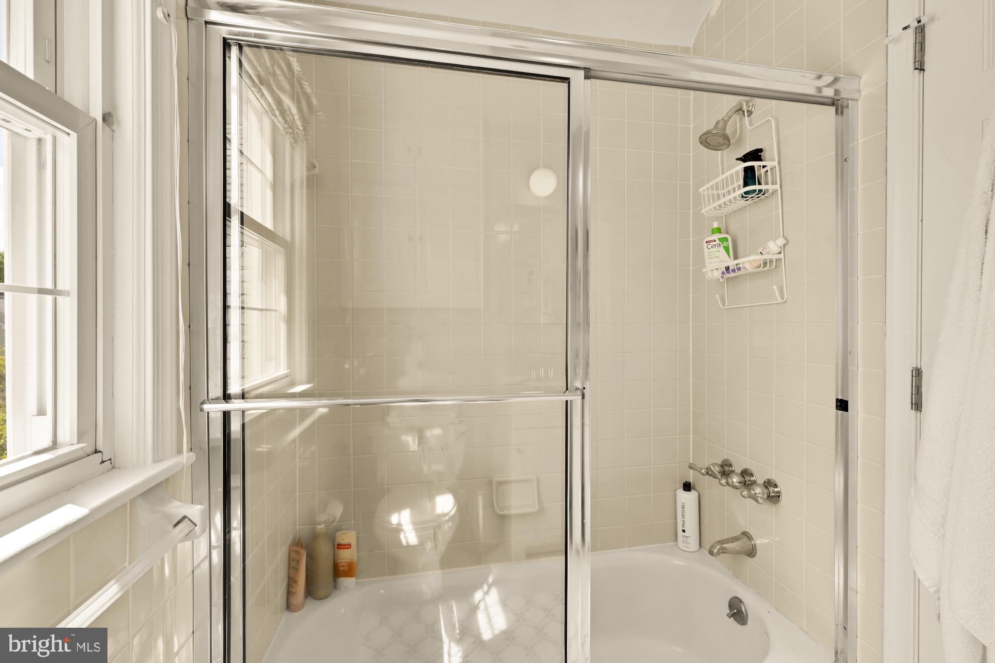 7208 Delfield Street Chevy Chase, MD 20815 - Photo 31 of 50 a bathroom with a shower and a bathtub