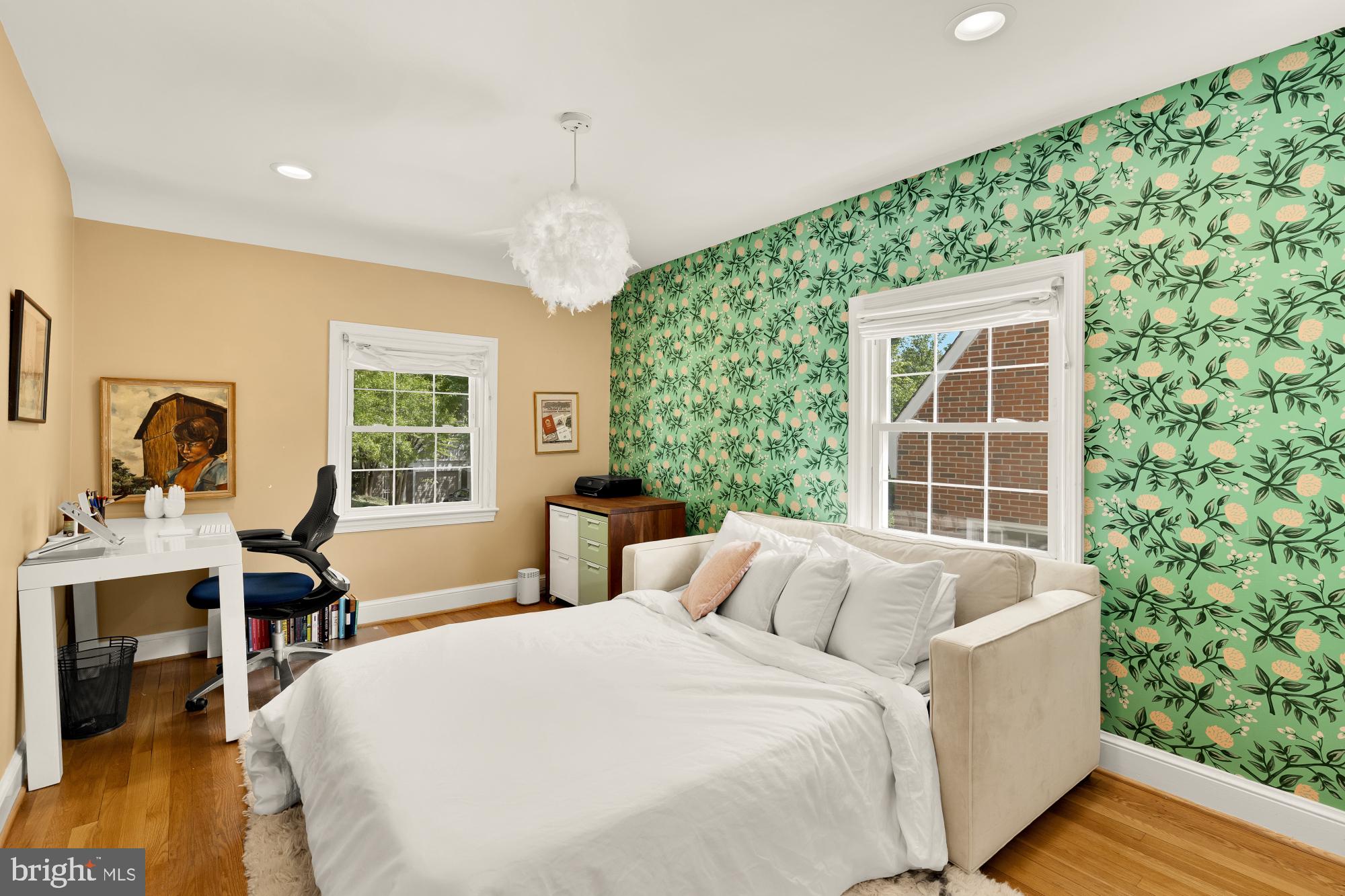 7208 Delfield Street Chevy Chase, MD 20815 - Photo 32 of 50 a spacious bedroom with a bed and a table