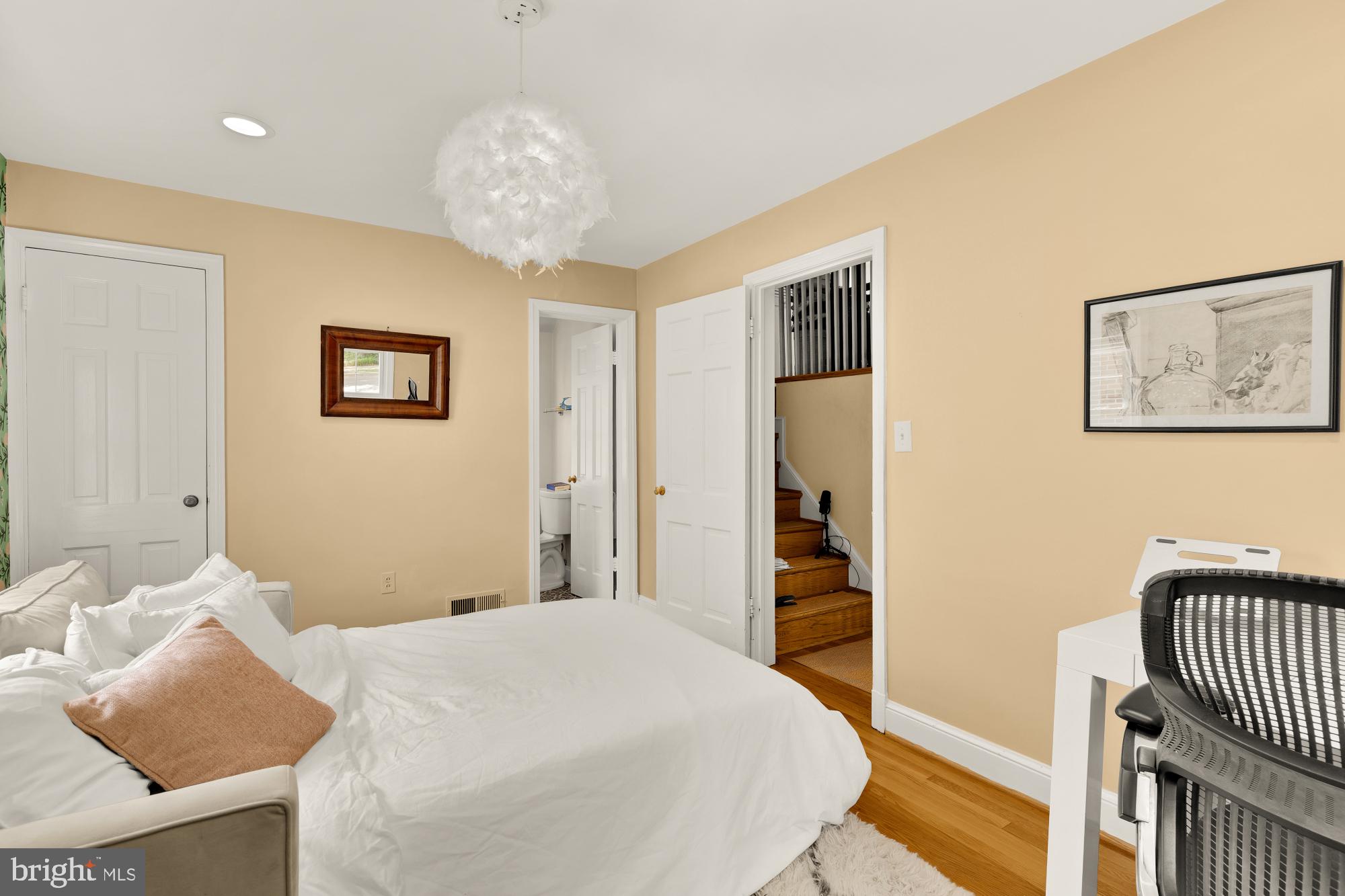 7208 Delfield Street Chevy Chase, MD 20815 - Photo 33 of 50 a bedroom with bed and a chandelier