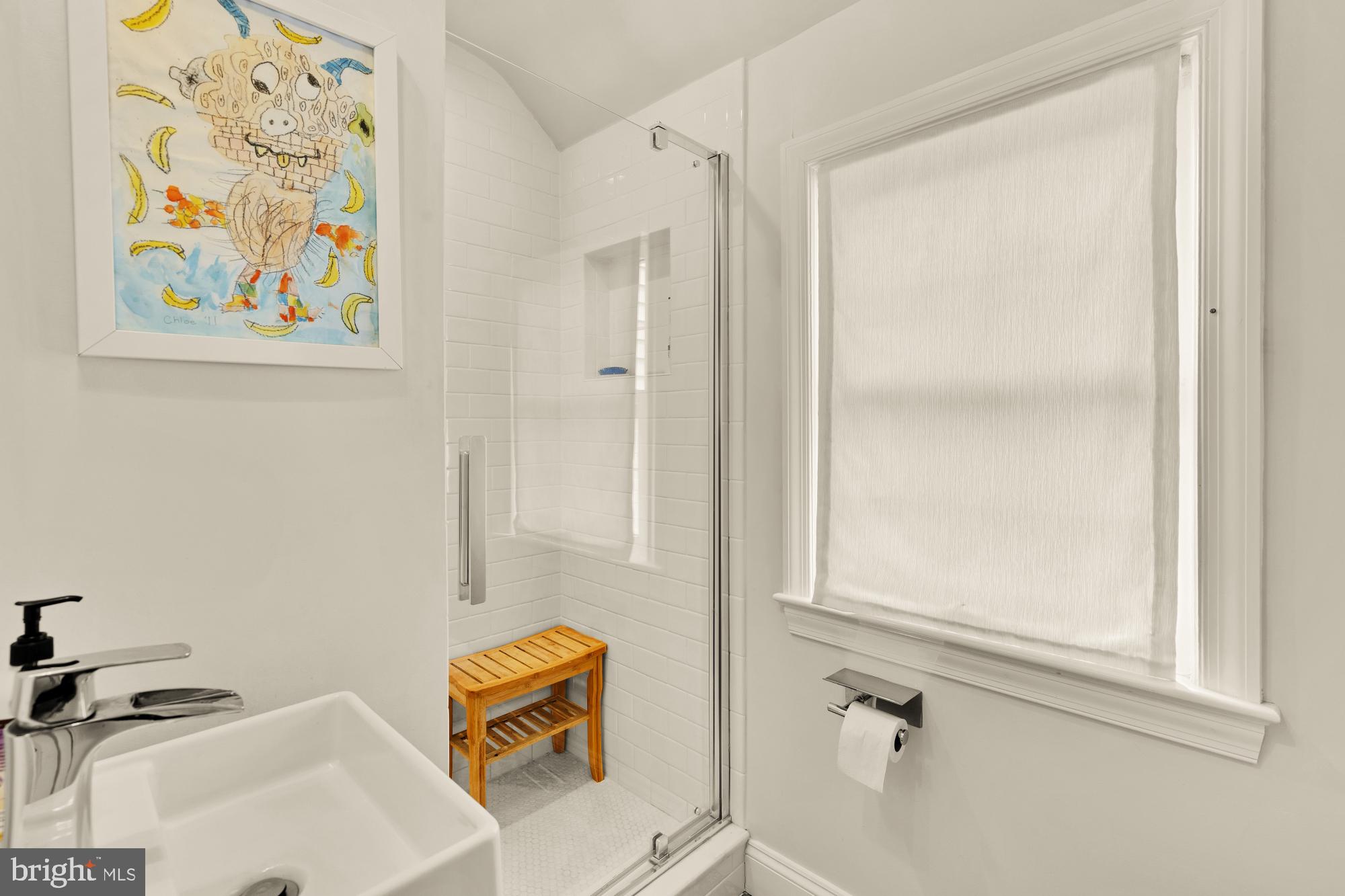7208 Delfield Street Chevy Chase, MD 20815 - Photo 34 of 50 a bathroom with a sink and a shower curtain
