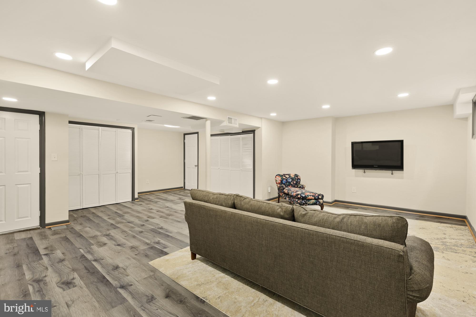 7208 Delfield Street Chevy Chase, MD 20815 - Photo 37 of 50 a living room with furniture and a flat screen tv