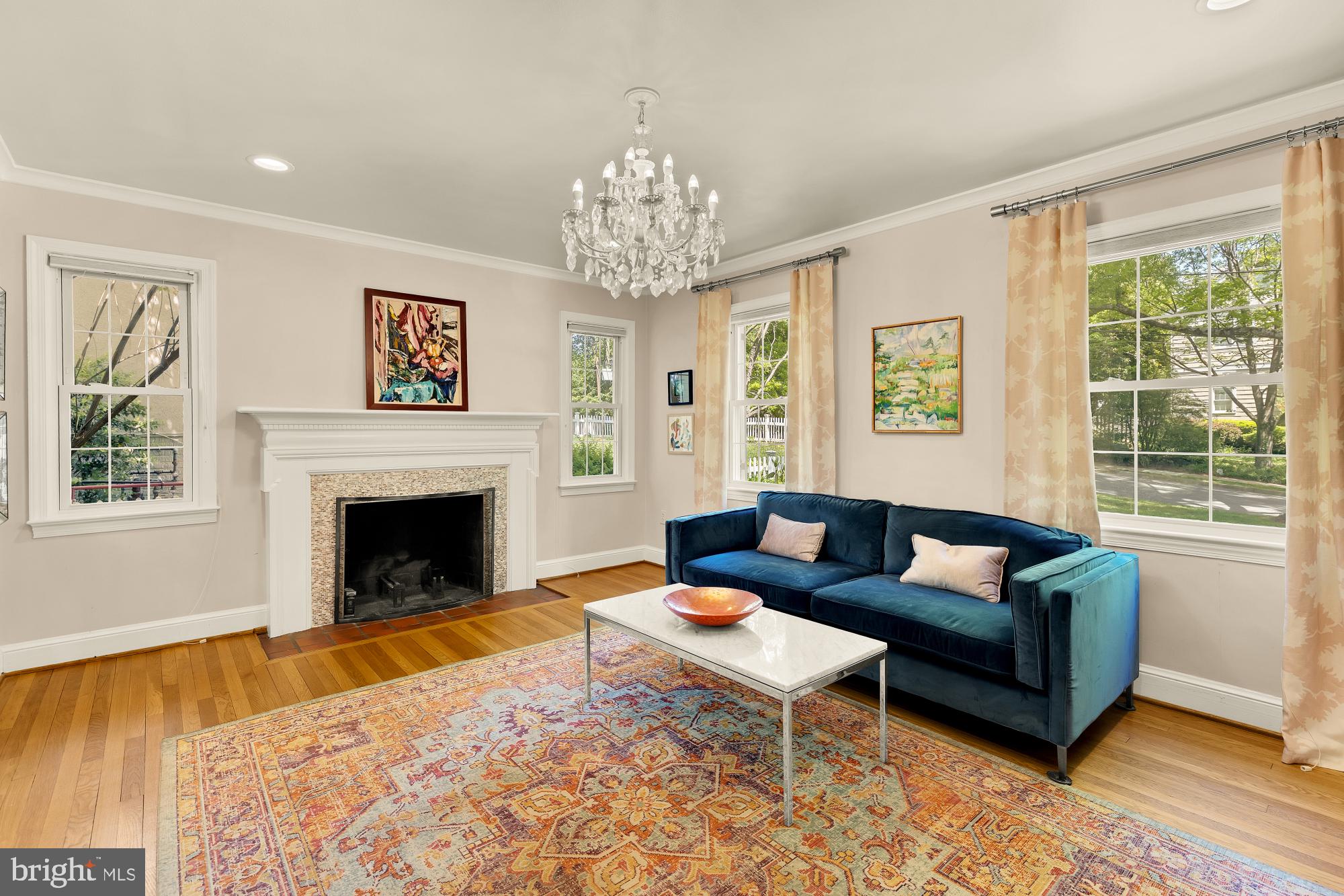 7208 Delfield Street Chevy Chase, MD 20815 - Photo 4 of 50 a living room with furniture a chandelier and a fireplace