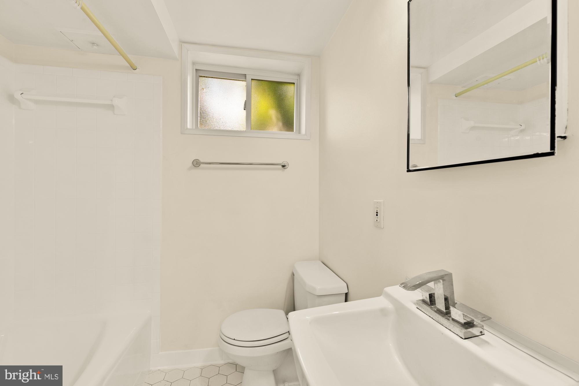 7208 Delfield Street Chevy Chase, MD 20815 - Photo 41 of 50 a bathroom with a toilet sink and mirror