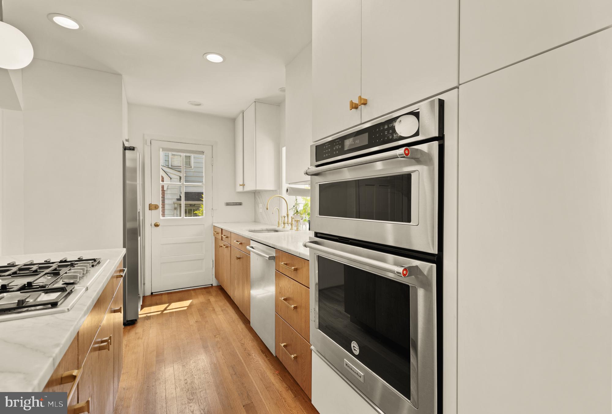 7208 Delfield Street Chevy Chase, MD 20815 - Photo 8 of 50 a kitchen with a stove oven and sink