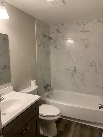 a bathroom with a sink a toilet and a bathtub