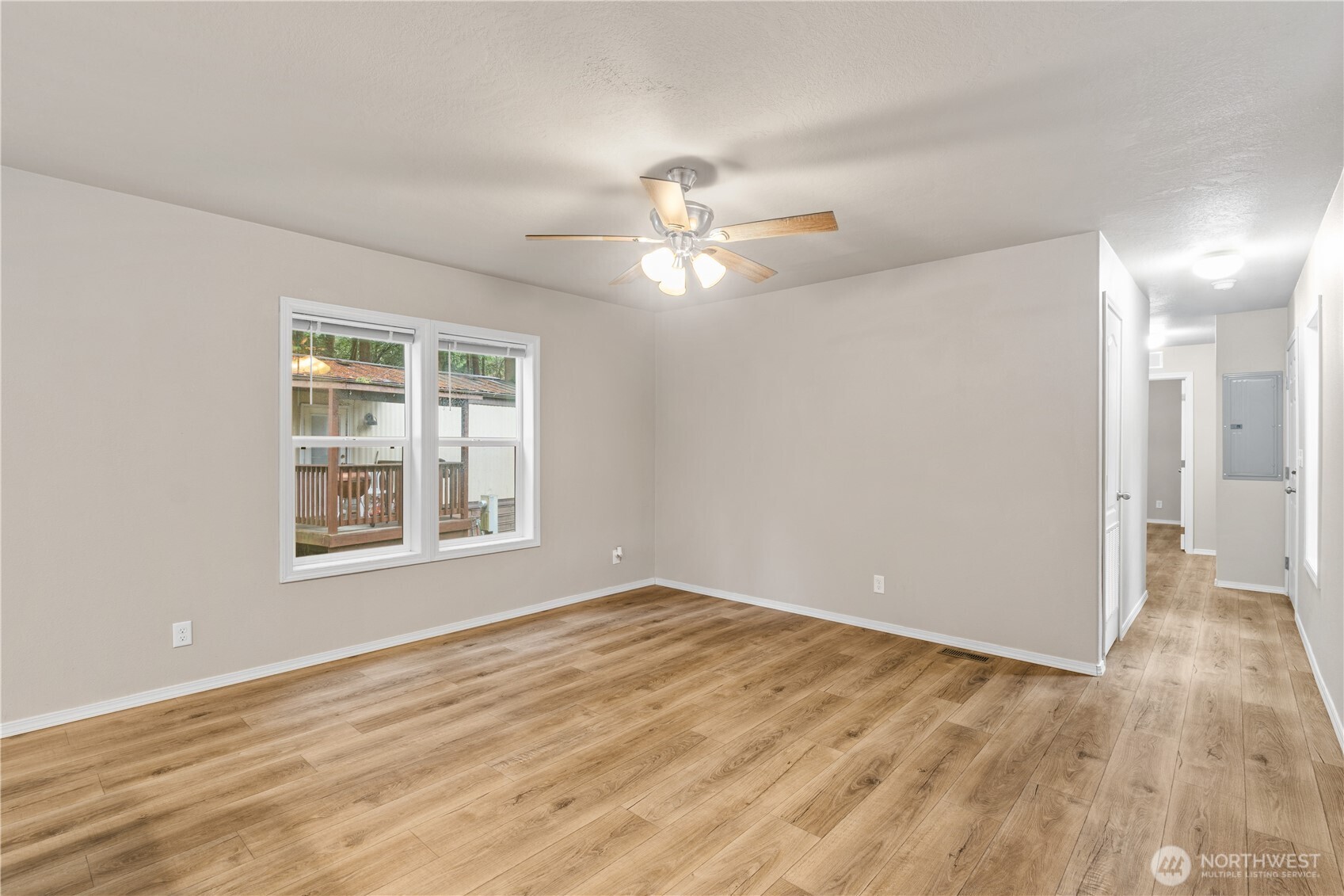 3557 Cedarville Road, Unit 25 Bellingham, WA 98226 - Photo 14 of 29 a view of an empty room with wooden floor and a window