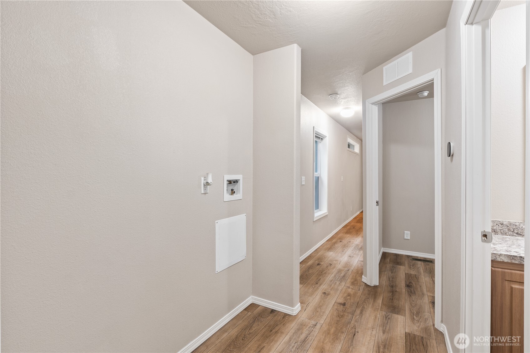 3557 Cedarville Road, Unit 25 Bellingham, WA 98226 - Photo 16 of 29 a view of a hallway with wooden floor