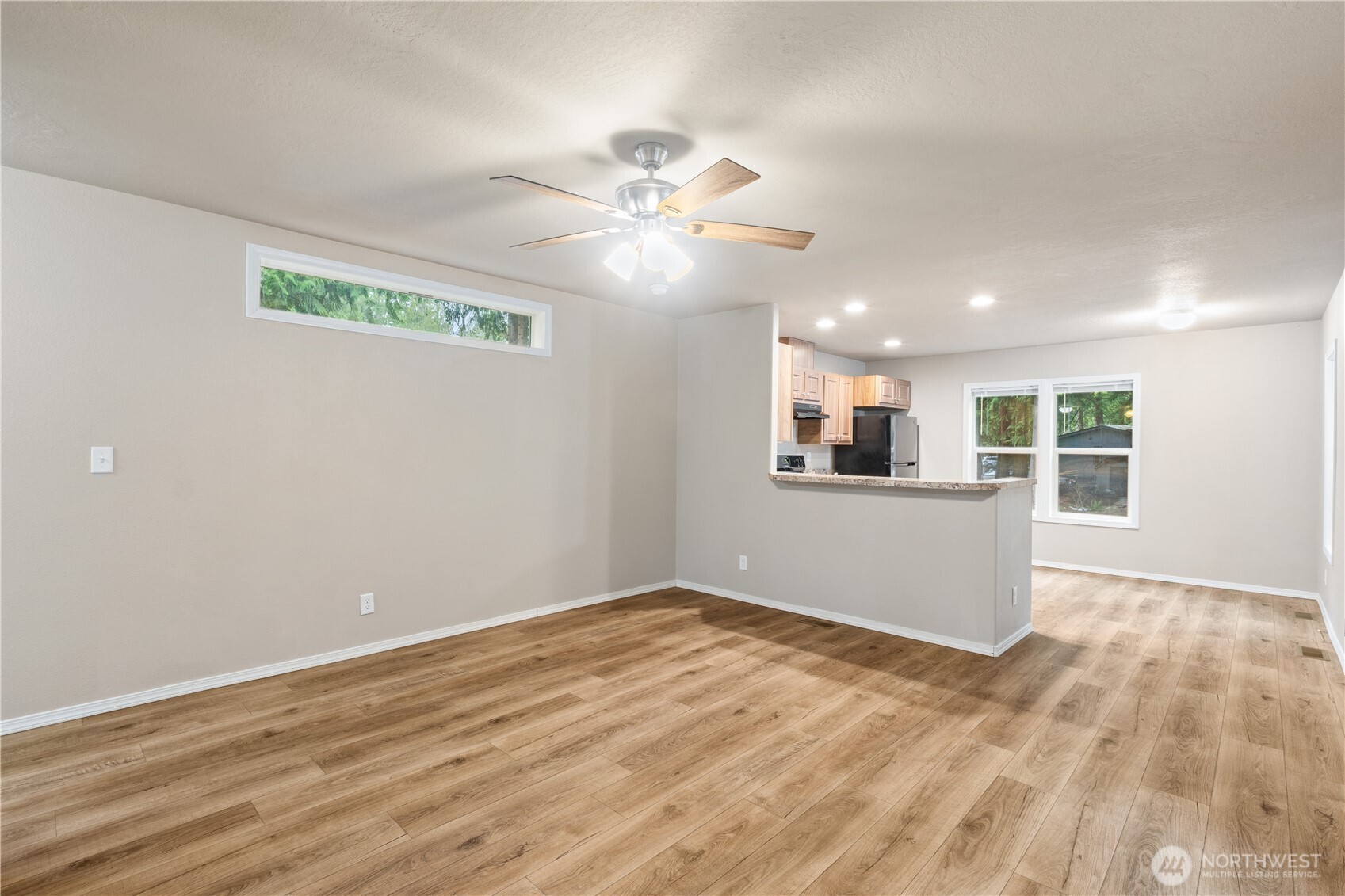 3557 Cedarville Road, Unit 25 Bellingham, WA 98226 - Photo 10 of 29 a view of a kitchen with wooden floor and a ceiling fan