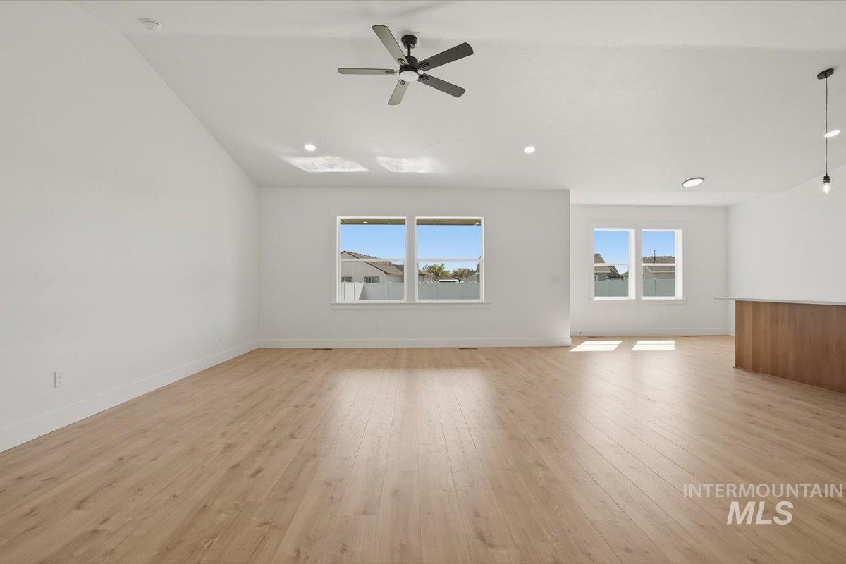 2175 Austin Way Fruitland, ID 83619 - Photo 6 of 30 Empty room featuring light wood-type flooring, a ceiling fan, plenty of natural light, vaulted ceiling, and recessed lighting