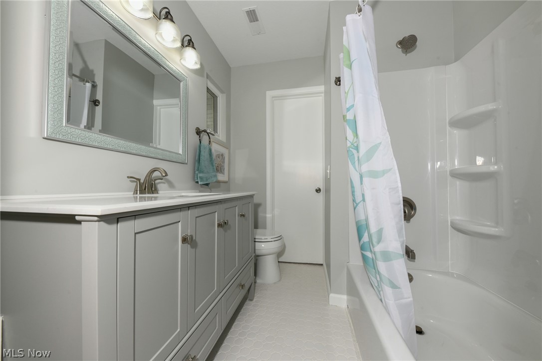 200 Hickory Road Akron, OH 44333 - Photo 26 of 35 Third Full bath- new octagon tile floor, cabinet, countertop, mirror lights and faucet! This bathroom can be accessed from privately from second bedroom