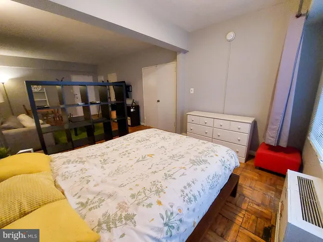 a bed sitting in a bedroom next to a window