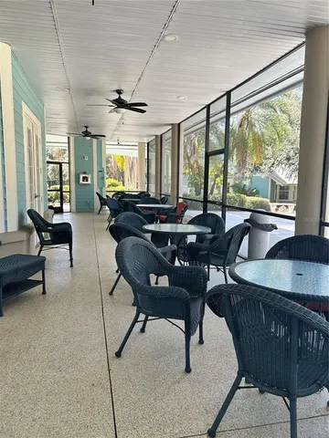a front view of a house with swimming pool patio and dining table