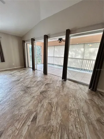 a view of an empty room with large windows