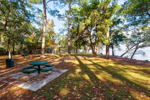 a view of a lake with table and chairs