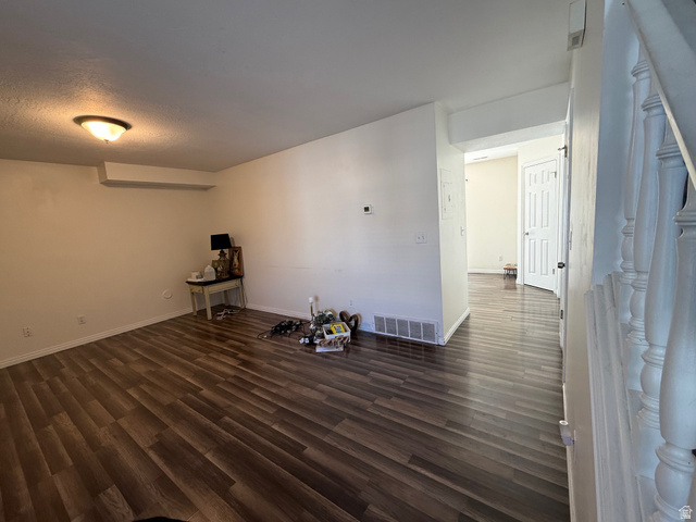 183 East 820 South Centerville, UT 84014 - Photo 3 of 14 Spacious room with wood-finish flooring, white baseboards, and neutral wall tones