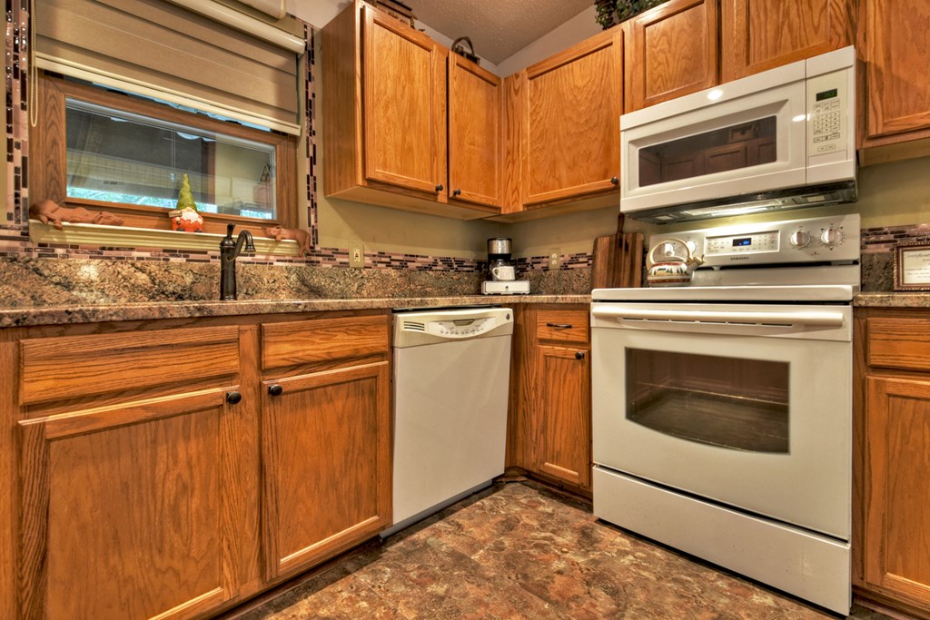 97 Mill Creek Acres Blue Ridge, GA 30513 - Photo 25 of 33 a kitchen with granite countertop cabinets stainless steel appliances and a counter space