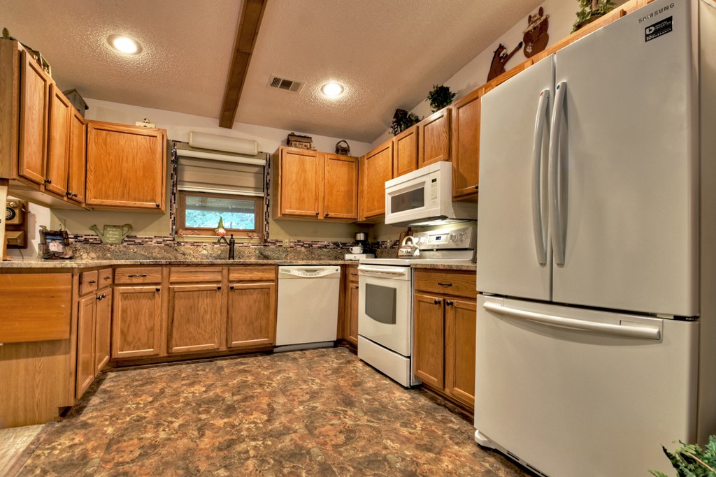 97 Mill Creek Acres Blue Ridge, GA 30513 - Photo 5 of 33 a kitchen with stainless steel appliances granite countertop a refrigerator sink and microwave
