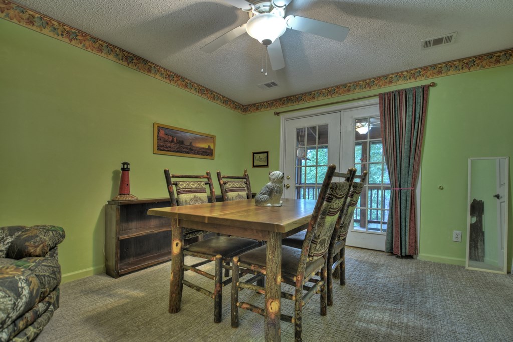 97 Mill Creek Acres Blue Ridge, GA 30513 - Photo 6 of 33 a view of a dining room with furniture and a chandelier fan