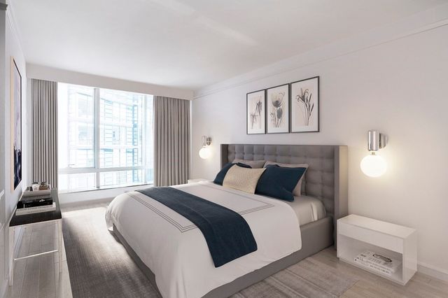 a bedroom with a bed and a large window