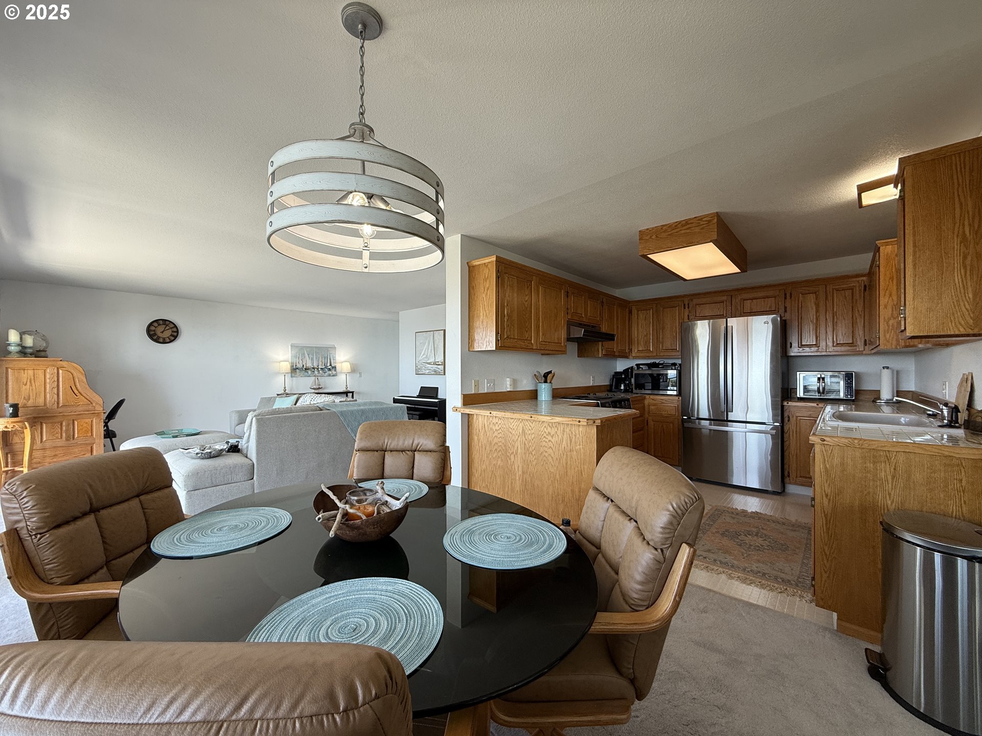 1305 Moore Street, Unit 402 Brookings, OR 97415 - Photo 12 of 28 a living room with furniture kitchen and a chandelier