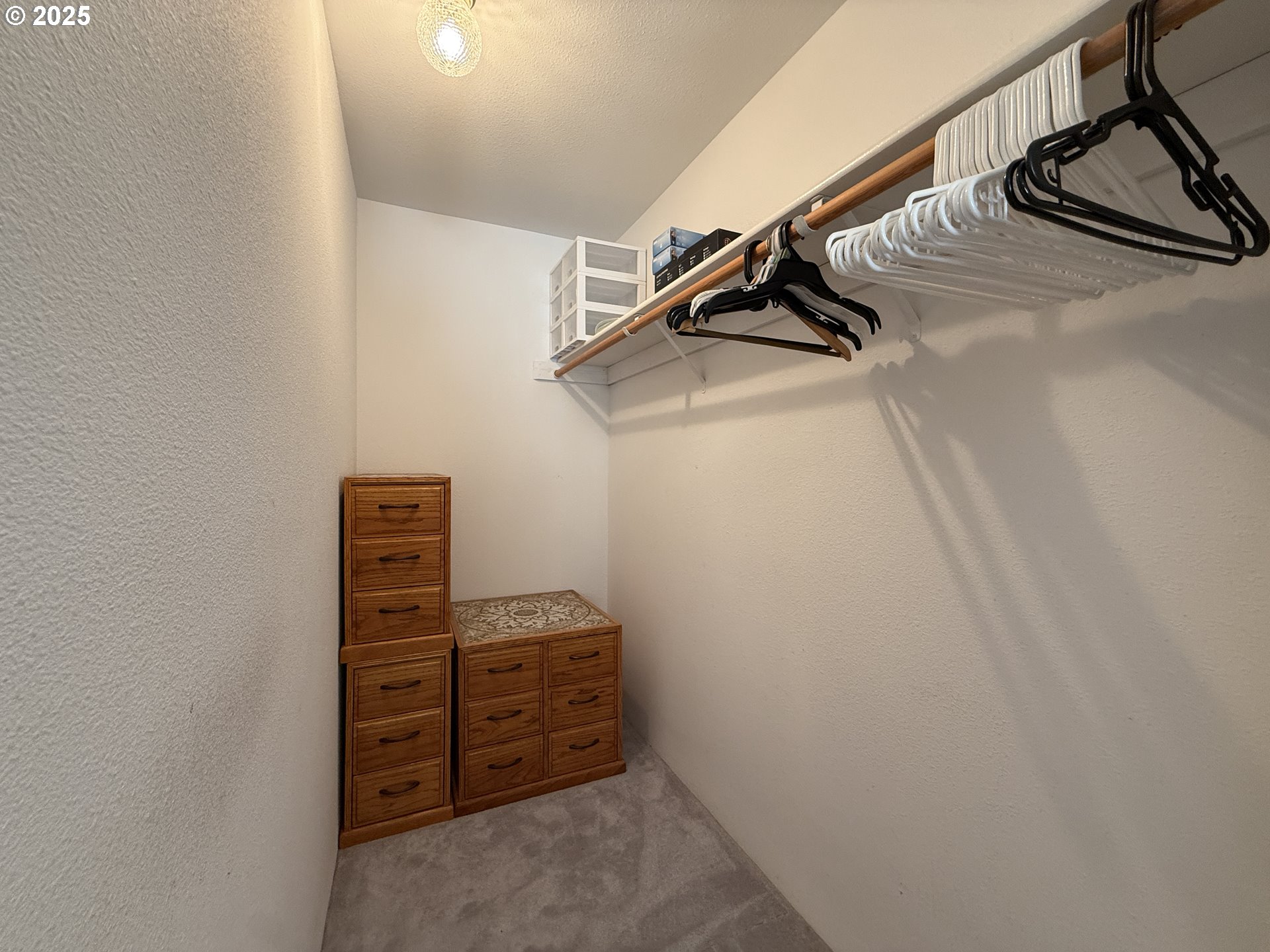 1305 Moore Street, Unit 402 Brookings, OR 97415 - Photo 22 of 28 a view of walk in closet with clothes