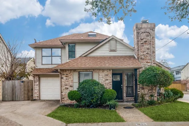 a front view of a house with a garden and plants