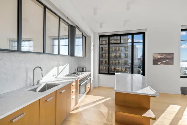 a living room with furniture and large windows