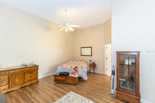 a bedroom with a large bed and a chandelier