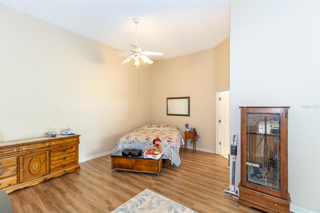 32025 Timberlake Drive Mount Dora, FL 32757 - Photo 11 of 55 a bedroom with a bed and wooden floor