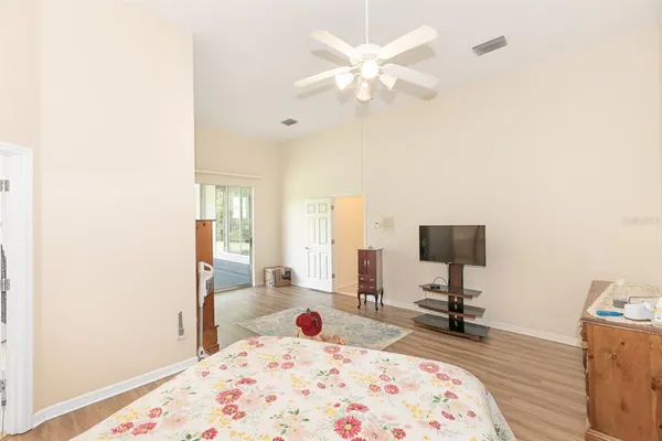 a view of a hallway with wooden floor and a living room