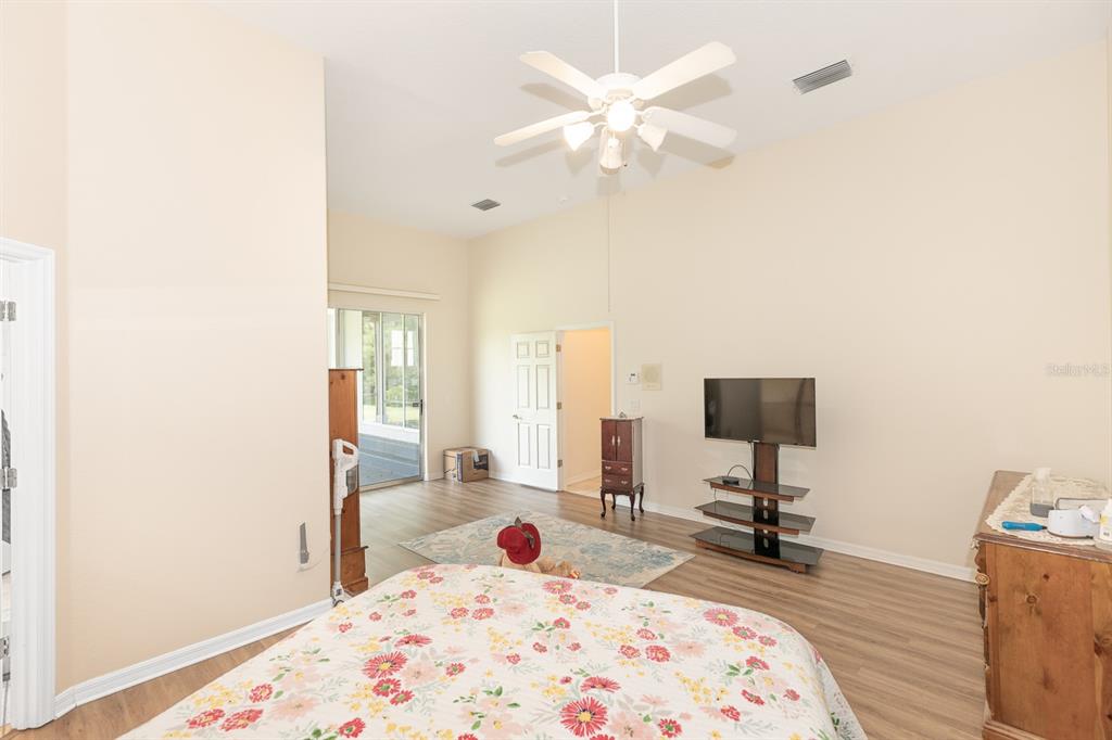 32025 Timberlake Drive Mount Dora, FL 32757 - Photo 13 of 55 a bedroom with a bed and a chandelier